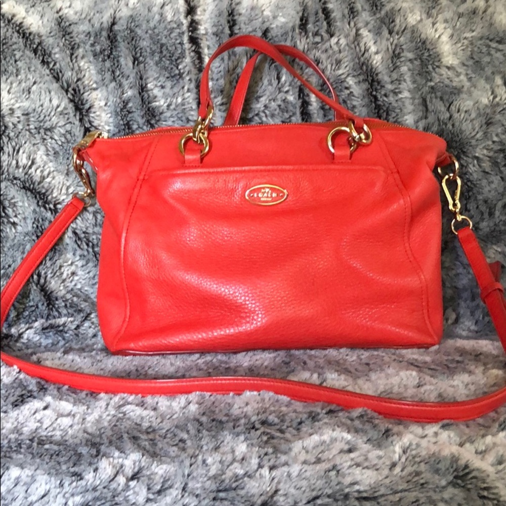 Coach leather purse with cross-body strap.